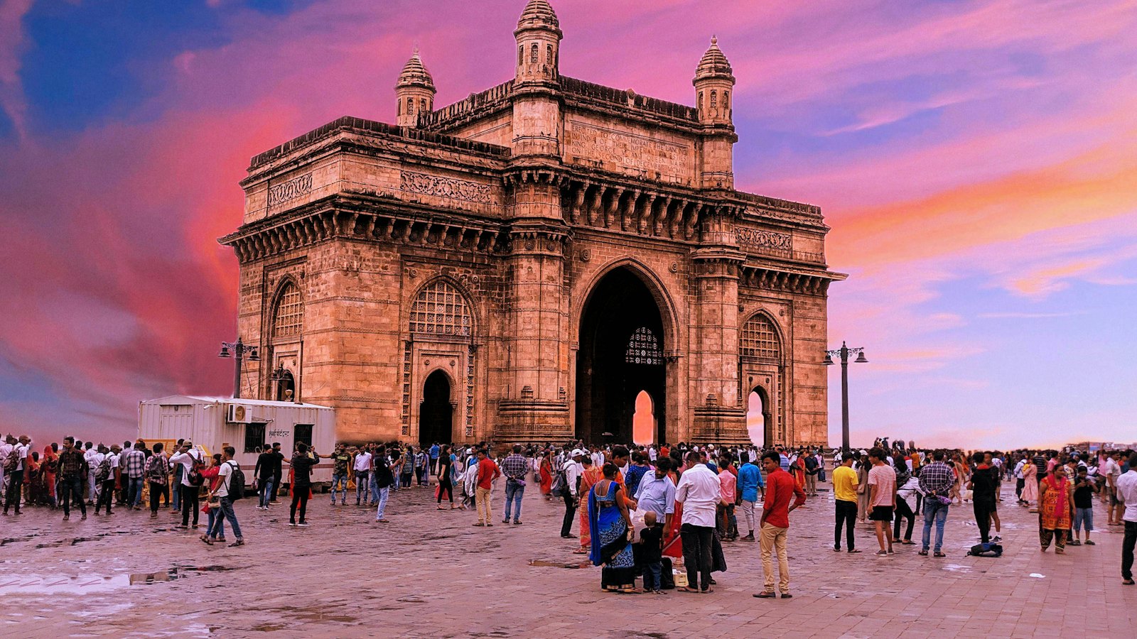 Gateway of India in Mumbai under a pink sunset sky