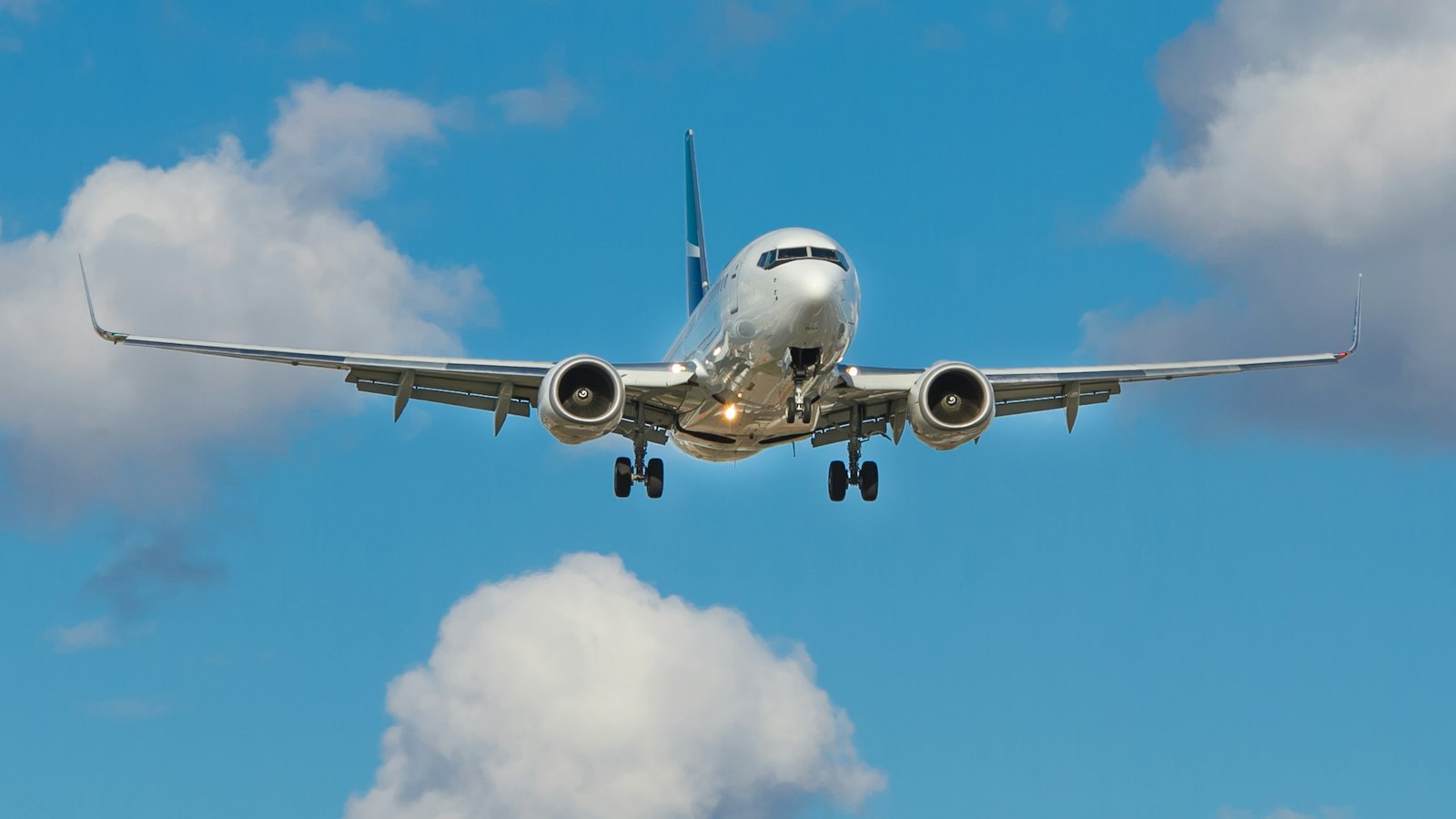 Passenger jet flying through a clear blue sky