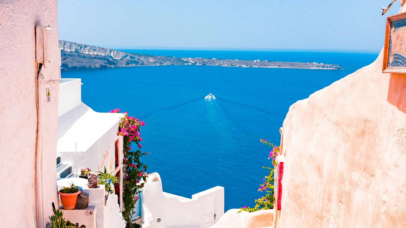 Whitewashed houses on a Santorini cliff above the blue Aegean