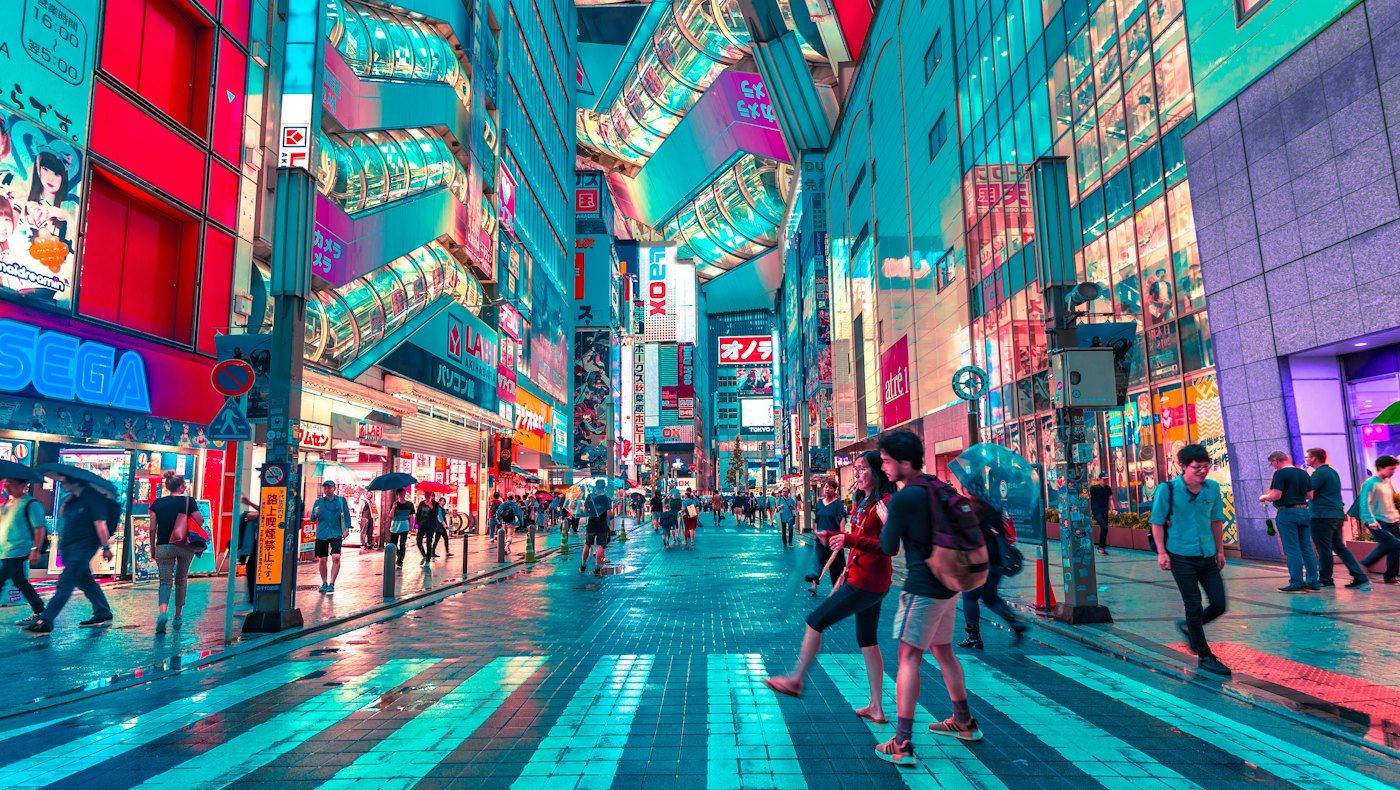 Busy Tokyo shopping street lit with neon signs